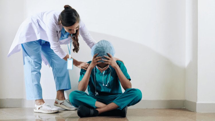 Establishing safe staffing in health and social care Nurse comforting over-stretched doctor in hospital