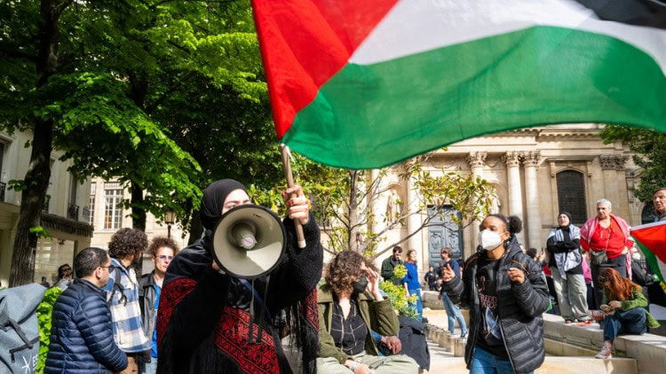 Recognition of Palestine pushes others to follow woman with Palestinian flag and megaphone