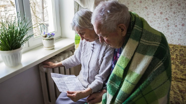 The European Investment Bank’s roadmap … to 2008 elderly couple wrapped in rug next to radiator scrutinise heating bill
