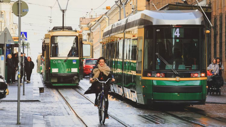 A new Green Deal: Europe's defining impulse trams and a cyclist in Helsinki