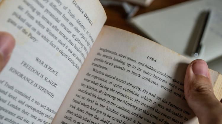 George Orwell and Europe’s new normal Two opened pages from Orwell's '1984', including examples of official 'Newspeak' such as 'WAR IS PEACE'.