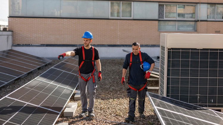 The European elections: the right lessons to learn two workers installing solar panels on the roof of a building
