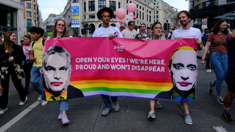 Populists back Putin with anti-Ukraine positions LGBT+ activists marching with a banner including the faces of Orban and Putin with lipstick and eye shadow