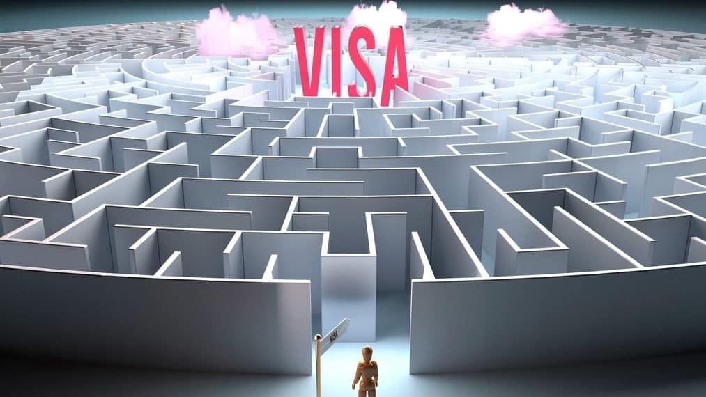 Stylised person at entrance to maze with the word VISA large and bright at its centre