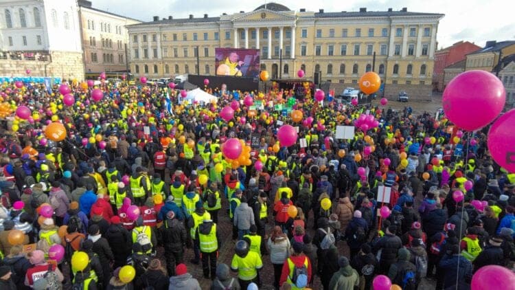 The assault on labour rights in Finland demonstration with large number of people in square in front of Finnish Senate in Helsinki