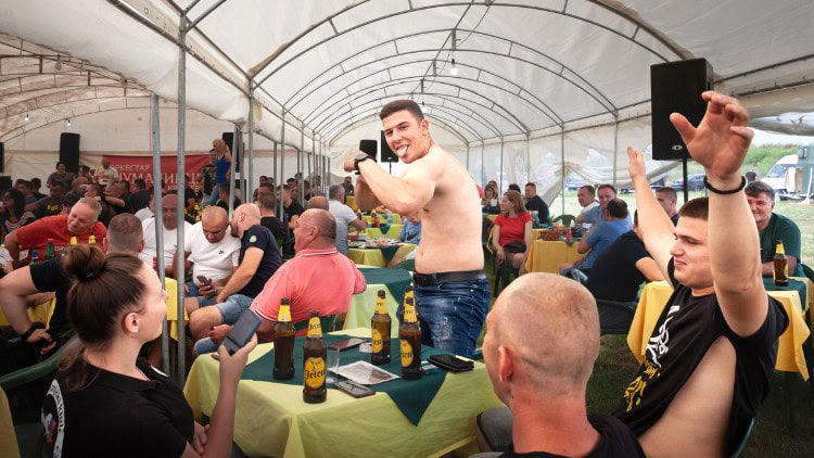Pornography, patriarchy and the western Balkans Man posing in macho way among crowd of drinkers