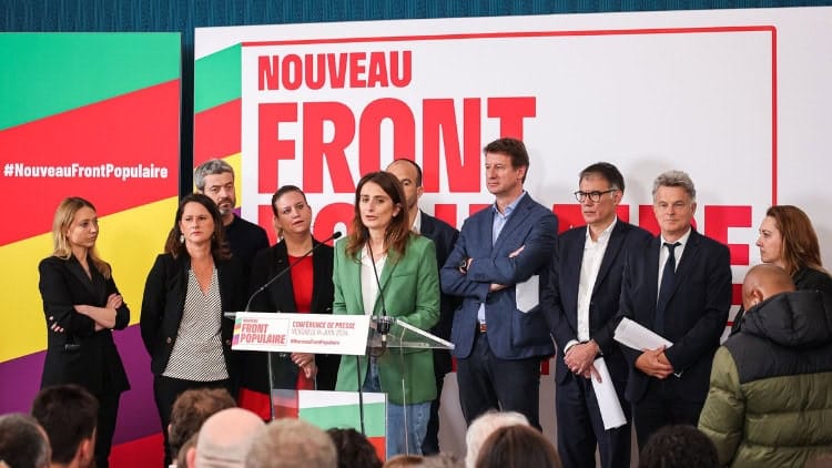 French voters united to block the far right again Group of politicians in front of Nouveau Front Populaire sign
