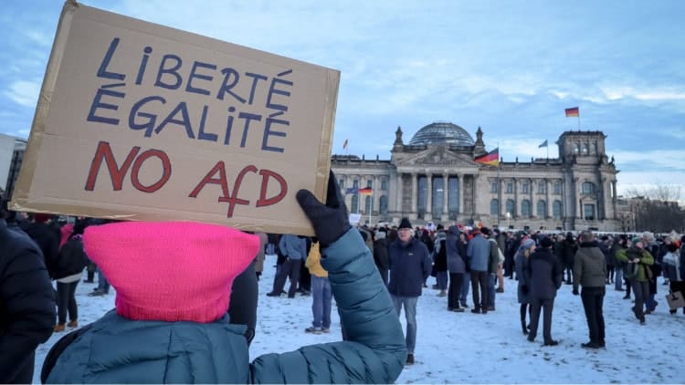 Why it seems east Germany is everywhere Woman with placard reading 'Liberté, Egalité, no AfD' outside Bundestag