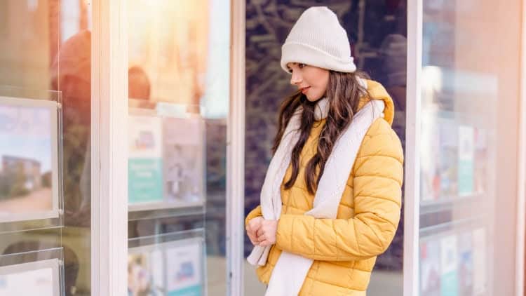 Housing cracks: multi-pronged approach required young woman staring into estate-agency window
