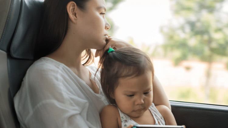 Stressed woman with child on bus